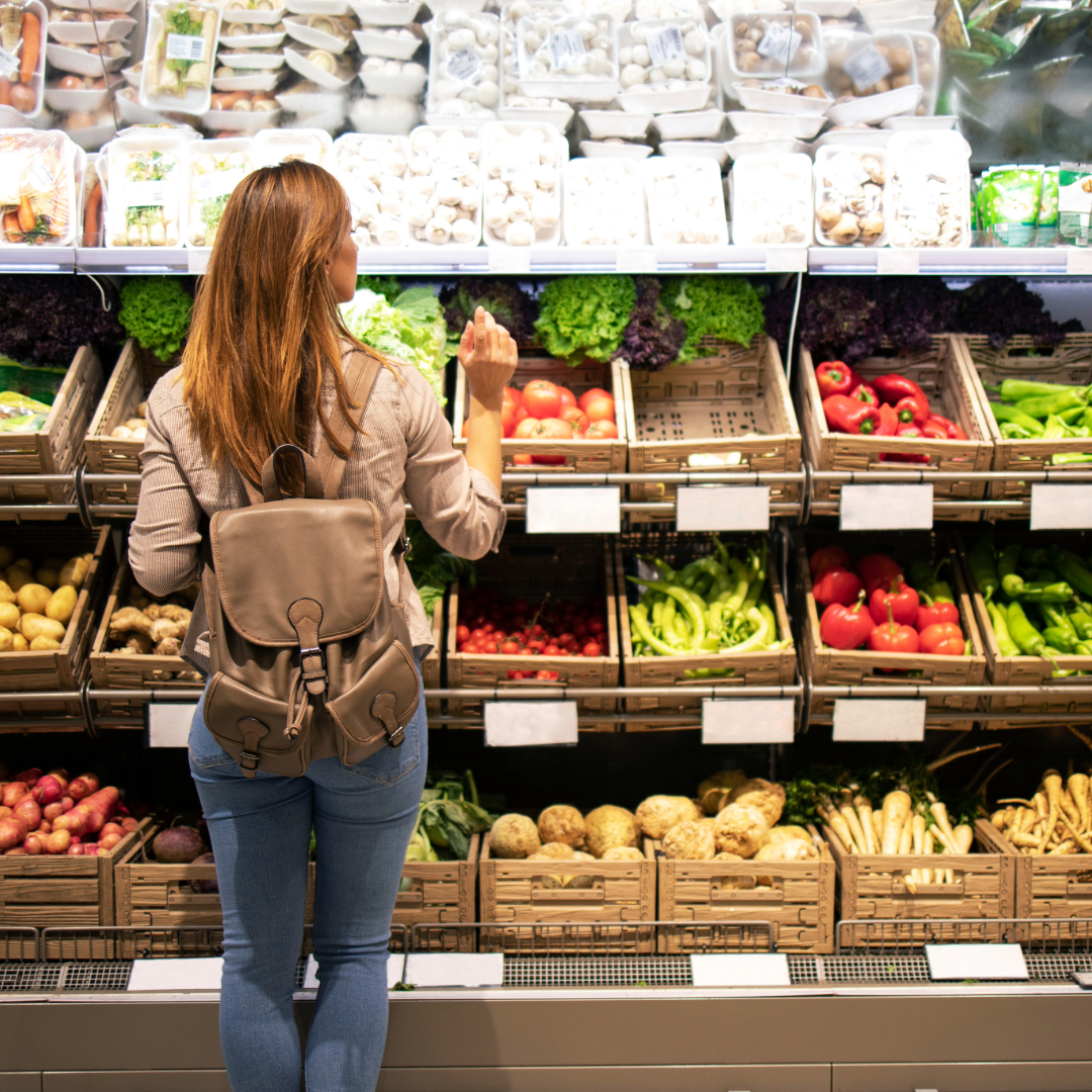 Women shopping in the organic vegetable isle